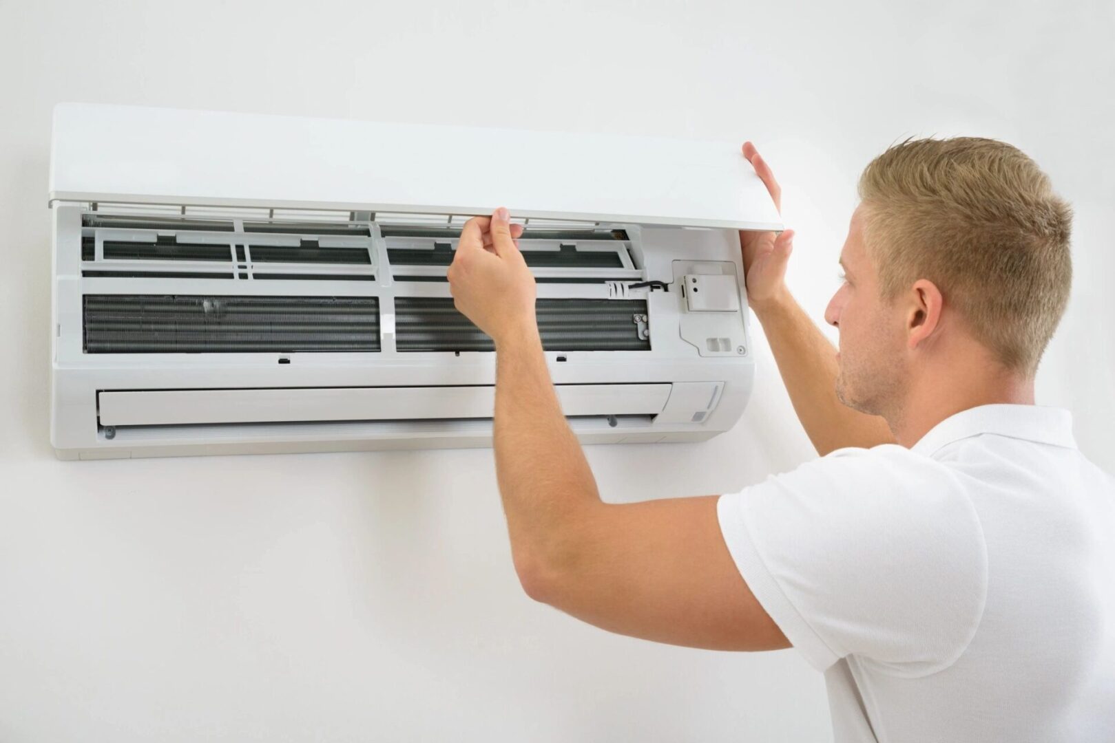 A Young Man Adjusting Air Conditioning System